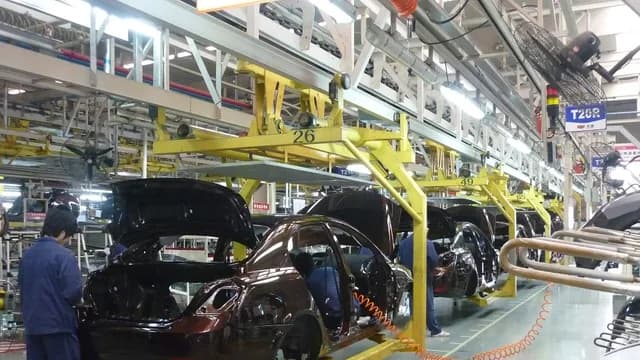 Car bodies moving through a Geely assembly line